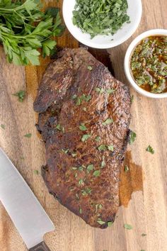 the steak is prepared and ready to be served on the cutting board with parsley