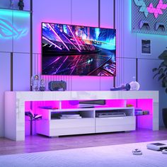 an entertainment center in a living room with purple lighting