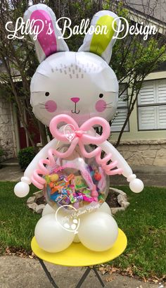 an inflatable balloon bunny sitting on top of a chair with balloons attached to it