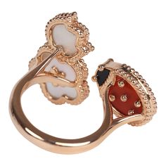 This Van Cleef & Arpels Lucky Spring Between the Finger Ring in Carnelian, Mother of Pearl and Onyx with 18K rose gold hardware, featuring a Carnelian and Onyx ladybug motif and one mother of pearl rose and one classic mother-of-pearl clover motif. Origin: FranceCondition: New and never wornAccompanied by: VCA gift box, VCA green jewelry box and authenticity card Measurements: ring size: 50 | US size: 5 1/4 Luxury Polished Enamel Ring For Wedding, Luxury Wedding Enamel Ring With Polished Finish, Luxury 14k Gold Enamel Wedding Ring, Luxury Enamel Ring, Luxury Polished Open Enamel Ring, Luxury White Oval Enamel Ring, Elegant Multi-stone Enamel Ring For Wedding, Elegant Multi-stone Enamel Ring For Formal Occasions, Onyx Van Cleef