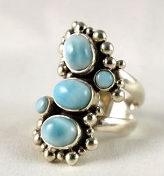 Be sure to add me to your favorites list! This ring is very unique as it like a piece of art.   The 5 Larimar stones are beautiful in color consisting of soft blue oval pieces  Dots complete the elegant feel. Setting with stones is 1 1/4" long about 5/8" wide Available in size 8  Size and measurements are approximate.   Stamped .925 on the inside band.  Shipping insurance included Check out our Ebay store for more great treasures! Visit My eBay Store: Reflections Bazaar International shipping rates apply outside the US     Our jewelry is new not previously worn. We are liquidating our inventory at bargain prices.  Please pay within 2 days of purchase. Attention International Customers: You must be willing to pay for insurance to ship this item, along with signature confirmation. Import dut Elegant Blue Larimar Turquoise Ring, Elegant Oval Larimar Rings, Spiritual Round Larimar Jewelry, Luxury Blue Larimar Ring, Unique Silver Larimar Rings, Earth Healing, Adjustable Blue Larimar Ring, Blue Larimar Cabochon Rings, Larimar Stone