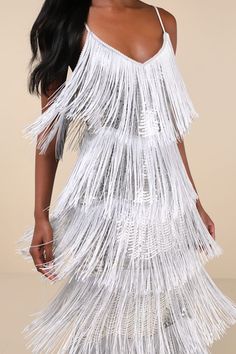 a woman wearing a white fringe dress