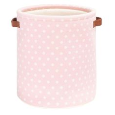 a pink and white polka dot fabric storage bin with brown leather handles on an isolated background