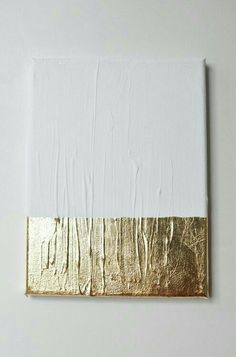 an abstract painting with gold and white paint