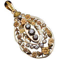 1880s -1890s An antique 18K gold pendant with finely chased and engraved multi-tone gold flower garlands, is embellished with half pearls and three old mine cut diamonds. Estimated total diamond weight is 0.82 ct. The pendant is marked with three French eagle-shaped assay marks in different places. The bail is detachable. Apparently, the pendant could be converted into something else. Probably it has been used as a centerpiece of tiara. Total length with bail 62 mm (2 7/16 in.) Width 31 mm (1 1/4 in.) Sold without chain Antique Gold Pendant, Victorian Pendant Necklace, Belle Epoch, Vintage Jewelry Rings, Natural Pearl Necklace, Art Nouveau Pendant, Nouveau Jewelry, Art Nouveau Jewelry, Antique Vintage Jewelry