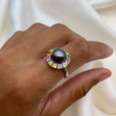 Black Pearl Ring set with a Natural Pearl in an AAA grade & natural black color, at 10mm diameter, from Japan, surrounded with Natural Citrine, Amethyst & Peridot, at 3mm each, 1.5 Carat combined, from Brazil. Band width 1.5mm. Pearl Flower Ring made of Solid 925 Sterling Silver ☞ made to last. Matching Earrings: www.etsy.com/listing/257621328 Matching Pendant: www.etsy.com/listing/558058800 June, November, February & August Birthstone * Genuine & Natural Stones * D E T A I L S ✓ Adina Stone GIF Luxury Mother Of Pearl Gemstone Rings, Luxury Pearl Birthstone Ring, Luxury Oval Cabochon Pearl Ring, Luxury Round Pearl Birthstone Ring, Luxury Round Pearl Ring With Cabochon, Luxury Multi-stone Pearl Ring In Fine Jewelry Style, Luxury Classic Multi-stone Pearl Ring, Luxury Multi-stone Pearl Ring Fine Jewelry, Luxury Multi-stone Heirloom Pearl Ring