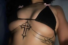 a woman with a cross tattoo on her back