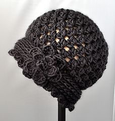 a crocheted hat is shown on a stand