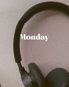 headphones sitting on top of a table with the words monday written in front of them