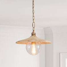 a light fixture hanging from a ceiling in a room with white walls and flooring