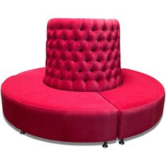 a pink round couch with wheels on the bottom and an armrest that is attached to it