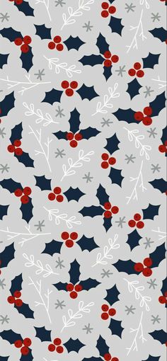 christmas holly and berries on grey background with red, white and blue leaves in the center