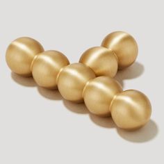 five golden eggs are arranged in a row