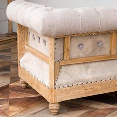 a wooden bench sitting on top of a hard wood floor