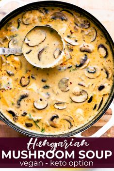 a pan filled with mushroom soup on top of a wooden table