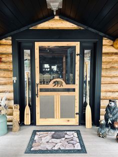 a bear statue sitting in front of a door with a screen on it's side