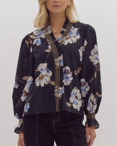 This Floral Print Top in classic black is the perfect combination of style and fun. With a vibrant floral pattern and a flattering fit, this versatile piece easily transitions from day to night. Rock your look and show off your playful personality with this must-have top! Floral print ruffle v-neck long sleeve top featuring embroidered smocking. Unlined. Woven. Non-sheer. Lightweight. 100% cotton Model is 5'10 and wearing a size small High Rise Bootcut Jeans, Color Block Cardigan, Black Floral Print, Trim Top, Top Floral, Long Puff Sleeves, Floral Print Tops, Clothes Gift, Print Top