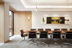 an empty conference table with chairs around it