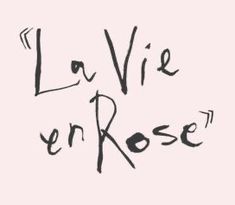 the words la vie en rose written in black ink on a gray background with an arrow