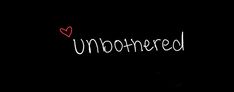 the word unborned written in white chalk on a black background with a red heart