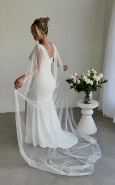 a woman in a white wedding dress and veil