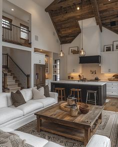 a living room filled with furniture next to a kitchen