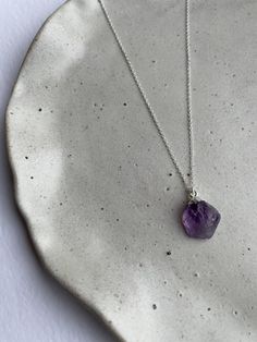 925 sterling silver raw amethyst necklace ✧ Material: 925 sterling silver chain & natural amethyst charm ✧ Chain Length: 16" or 18" ✧ Charm measurements: approx 12-16mm in height  ✧ Packaging: placed into a suede pouch (perfect for gift giving!) Please note slight variations in size and colour may occur as item is a natural gemstone! Healing Sterling Silver Birthstone Necklace With Gemstone, Purple Amethyst Necklace With Raw Stone, Minimalist Sterling Silver Gemstone Necklaces, Amethyst Pendant Necklace With Raw Stone, Minimalist Amethyst Gemstone Jewelry, Minimalist Sterling Silver Gemstone Necklace, Sterling Silver Pendant Necklace With Raw Stone, Amethyst Raw Stone Pendant Necklace, Purple Sterling Silver Crystal Pendant Necklace