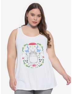 a woman wearing a white tank top with totoro on it