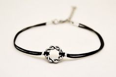 Karma anklet - black anklet with a silver tone braided circle charm. The color of the cord is black and it is made of waxed cotton. The circle charm is made of alloy. The anklet come with an extension so it is adjustable. Closure: clasp. You can request a thread in a different color from the colors shown in the last picture.The anklet is 8 1/2" (21.5cm) long plus a 1 1/2" (4cm) extension. If you would like a different length, write your request at checkout and we will make it for youThis anklet Casual Silver Anklets For Gifting, Handmade Black Sterling Silver Braided Bracelet, Casual Silver Anklets As Gift, Casual Silver Anklets For Gifts, Minimalist Silver Braided Bracelet With Adjustable Cord, Silver Minimalist Braided Bracelet With Adjustable Cord, Black Sterling Silver Bracelets With Adjustable Cord, Sterling Silver Black Bracelet With Adjustable Cord, Black Sterling Silver Bracelet With Adjustable Cord