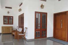 an empty room with wooden doors and chairs