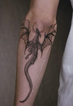 a man with a dragon tattoo on his arm