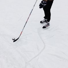 a person on skis is standing in the snow with their legs up and poles down