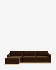 a brown couch sitting on top of a white floor