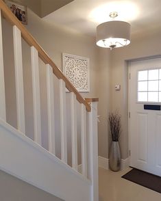 a white door and some stairs in a house