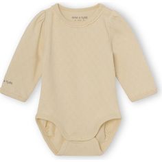 Onesie in a soft organic pointelle jersey from MINI A TURE. The onesie has long sleeves and snap-button at bottom and shoulder. This product is made in 100% organic cotton and is GOTS-certified, which means that the product is manufactured in a sustainable and socially responsible way from cotton-seed to final product. More color options available | Mini A Ture | Organic Akeleje Body, Marzipan (Beige, Size 1M)  |  Maisonette collects the best children’s products from around the world (unlike Zul Cream Long Sleeve Onesie For Loungewear, Cream Long Sleeve Cotton Onesie, Fall Long Sleeve Beige Bodysuit, Casual Beige Cotton Bodysuit, Beige Long Sleeve Onesie For Loungewear, Long Sleeve Cream Onesie For Spring, Cream Long Sleeve Onesie For Spring, Beige Long Sleeve Cotton Onesie, Cream Long Sleeve Onesie For Fall