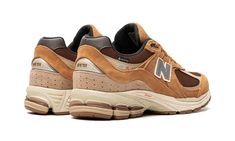 The New Balance 2002R Gore-Tex “Tobacco” is a version of the retro running shoe with a rugged, weatherproof design.  The “Tobacco” 2002R features a Gore-Tex membrane underneath its brown mesh base.  Contrasting Tobacco-colored suede overlays are found throughout the design.  A grey leather “N” appears on both sides of the shoe and “2002R” branding is found on the lateral side of the heel.  “Gore-Tex” branding is located on the heel and on the branding tag on the collar.  Underfoot, the cream foa New Balances Brown, Brown New Balance Sporty Sneakers, New Balance Brown Sporty Sneakers, Sporty Brown New Balance Sneakers, New Balance 2002r Protection Pack Vintage Orange, Retro Running Shoes, New Balance 2002r, Stadium Goods, The Cream