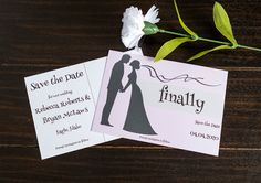 two wedding save the dates cards with flowers on wooden table next to eachother