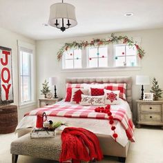 a bedroom decorated for christmas with red and white decor