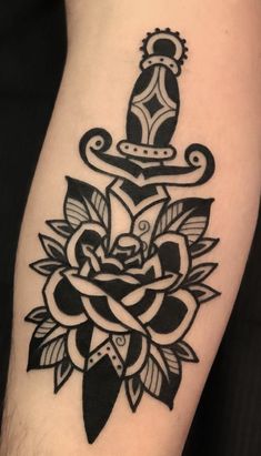 a black and white tattoo design on the arm