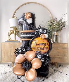 an assortment of halloween decorations and balloons on a table with a mirror in the background