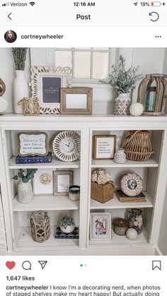 a white bookcase filled with lots of different items