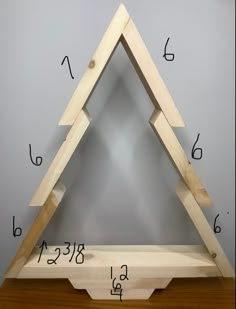 a wooden triangle with numbers on it and measurements for each piece to be made out of