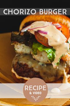 a cheeseburger with lettuce, tomato and onions on it is sitting on a plate