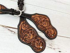 the leather dog leash has two large brown flowers on it