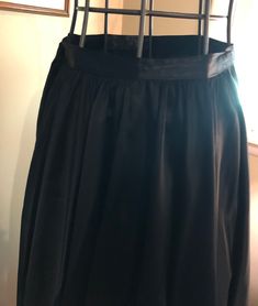 I am offering a beautiful 1950s black matte satin skirt. The skirt falls gracefully from its natural waistline. It is gathered. It is ankle length. It would be perfect as a recital skirt or for formal wear. It has a hook and snap closure. Measurements on request. Black Pleated Silk Skirt, Formal Black Gathered Skirt, Black Gathered Skirt For Evening, Black Flowy Pleated Skirt For Formal Events, Black Silk Voluminous Skirt, Black Flowy Pleated Skirt For Formal Occasions, Formal Black Flowy Pleated Skirt, Black Silk Pleated Skirt Bottoms, Formal Black Voluminous Skirt