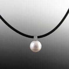 Pearl Necklace - This classic south seas pearl pendant has a modern edge with the square bail which can be interchangeable with different chains.  It is shown here on a black rubber cord.  Pearls are irregular and imperfect each one is unique.  Pearls measure 13-14mm. Bail is 6 mm square. Necklace is available in 16L or 18L. Please enter your desired length in the box below. Modern Pearl Pendant Necklace, Square Necklace, Artful Home, Sea Pearl, South Seas, South Sea Pearls, Sea Pearls, Black Rubber, Pearl Pendant