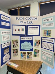 a table with a poster on it that says rain clouds in a jar