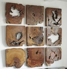 several pieces of wood that have been cut into squares and placed on a wall in a room