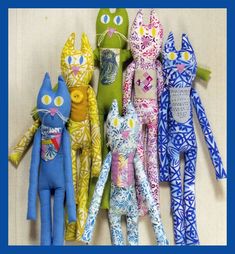 the sewing pattern for stuffed cats is shown in several different colors and sizes, including one blue