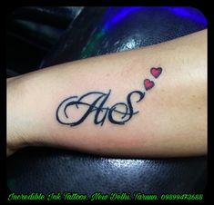 an arm tattoo with hearts and the word aos written in cursive writing